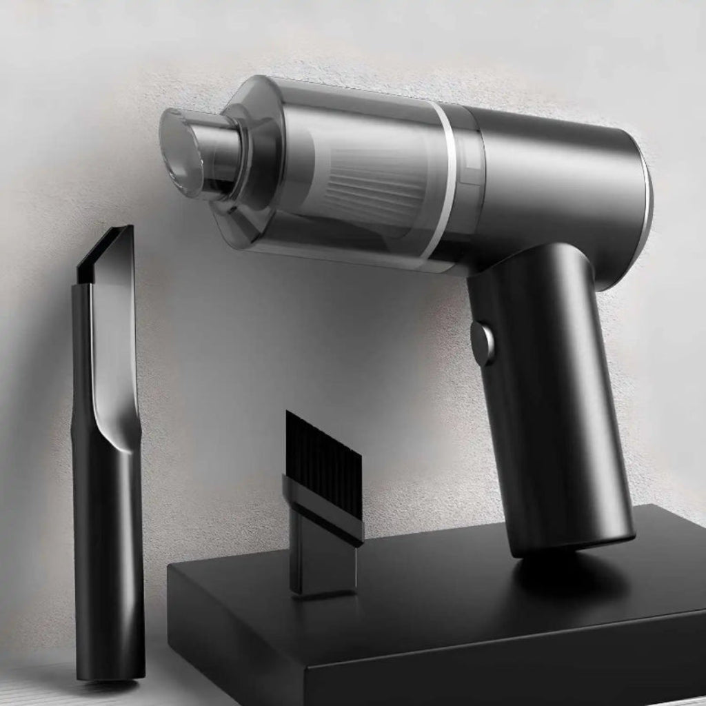 Silver handheld vacuum cleaner on a black stand with a neutral background