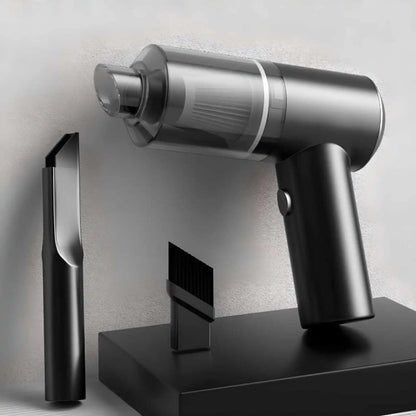 Silver handheld vacuum cleaner on a black stand with a neutral background