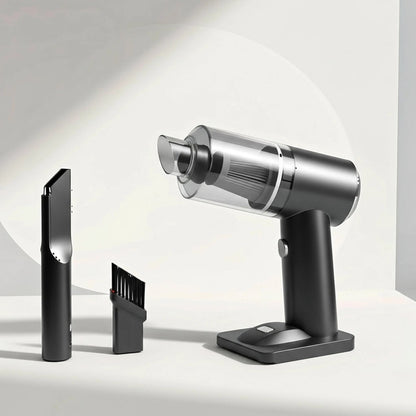 Silver handheld vacuum cleaner with attachments on a light gray background